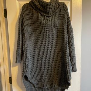 Gray knitted knee length sweater dress with crowl neck.